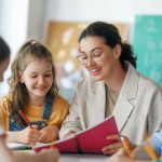 Happy kids and teacher at school